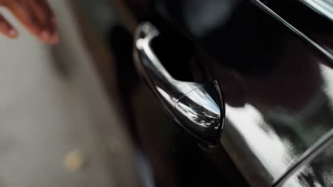 man's hand close-up opening the car door in slow motion