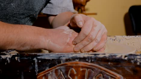 professional male potter making ceramics in workshop