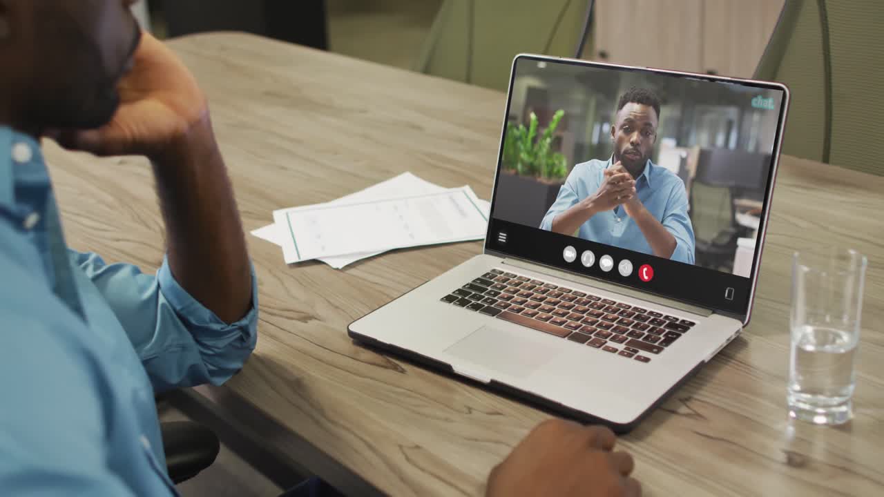 Video of afrcian american man having video call on laptop