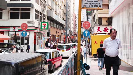 pedestrians and vehicles on a busy urban street