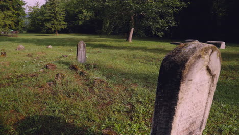 the most cinematic closeup panning view of a tombstone with notes of an old christian grave in the graveyard