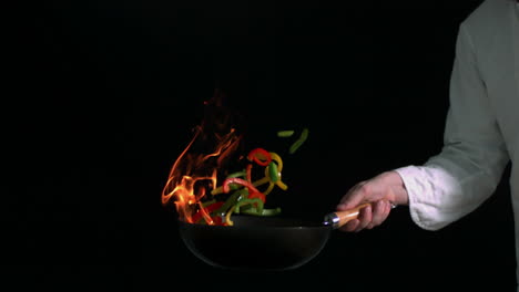 peppers burning in a pan with little flame