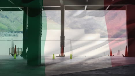 in parking garage, traffic cones placed with mountain view through large opening