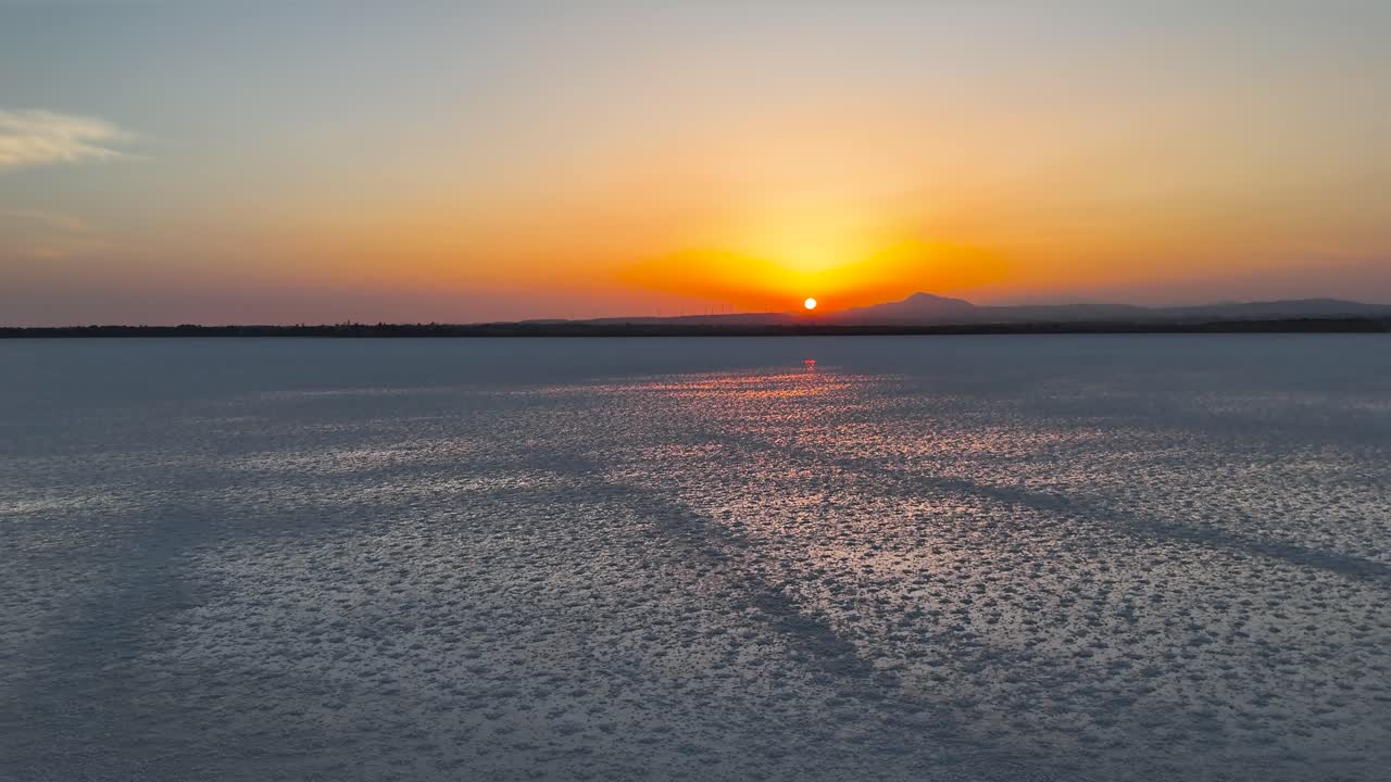 Aerial ascend over Larnaca salt lake wetland during beautiful sunset, Cyprus
