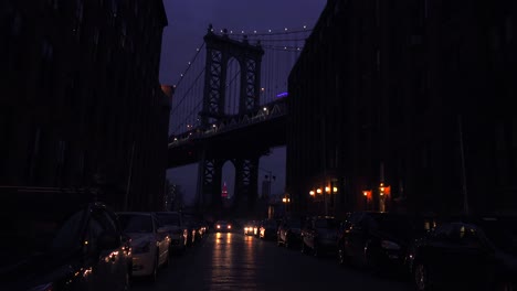 a nice view of a brooklyn new york street with the bridge background and apartments foreground