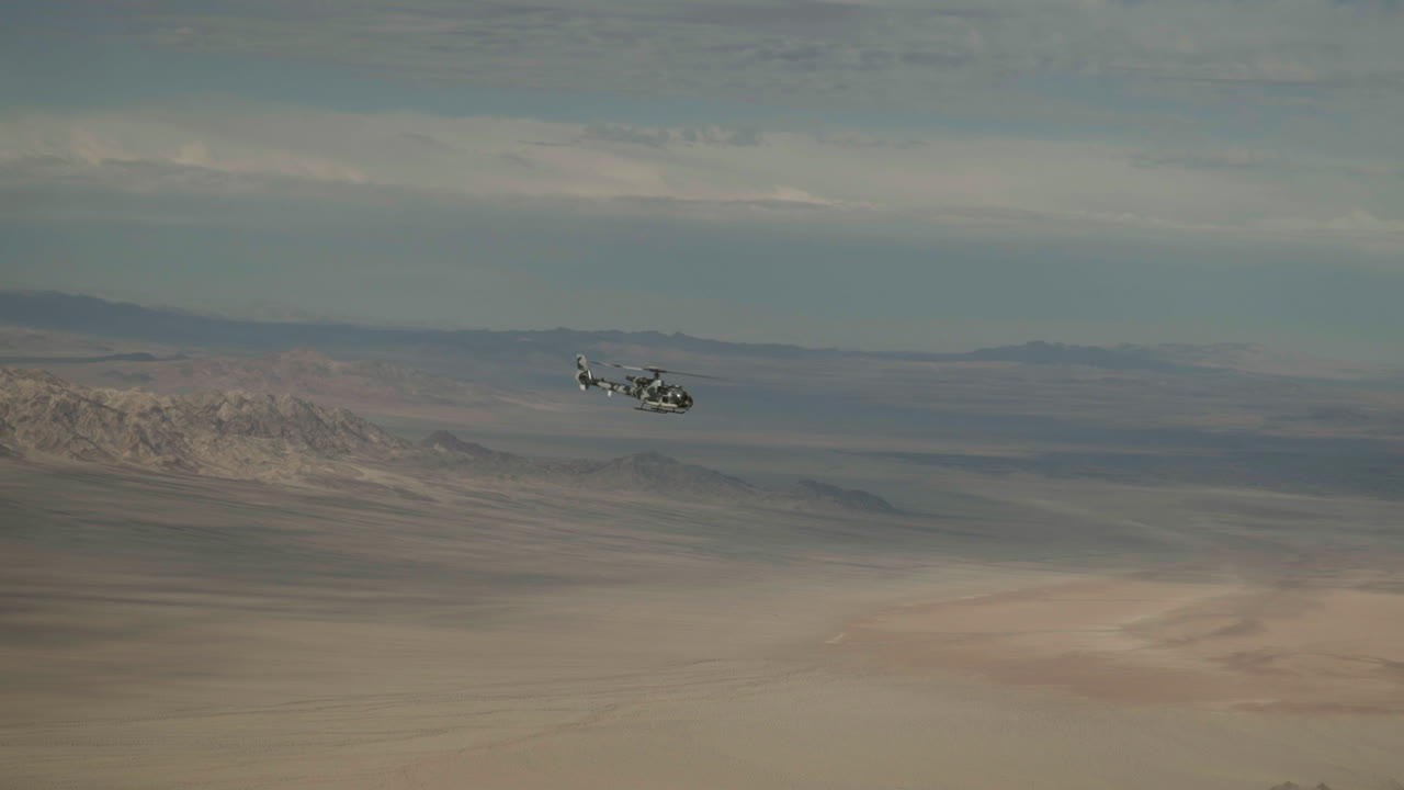 Military helicopter glides smoothly through desert skies, showcasing agility during a training mission.