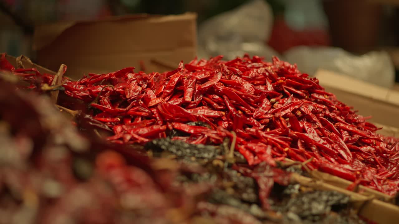 ZOOM OUT SHOT OF DRIED CHILIS IN A MARKET IN OAXACA