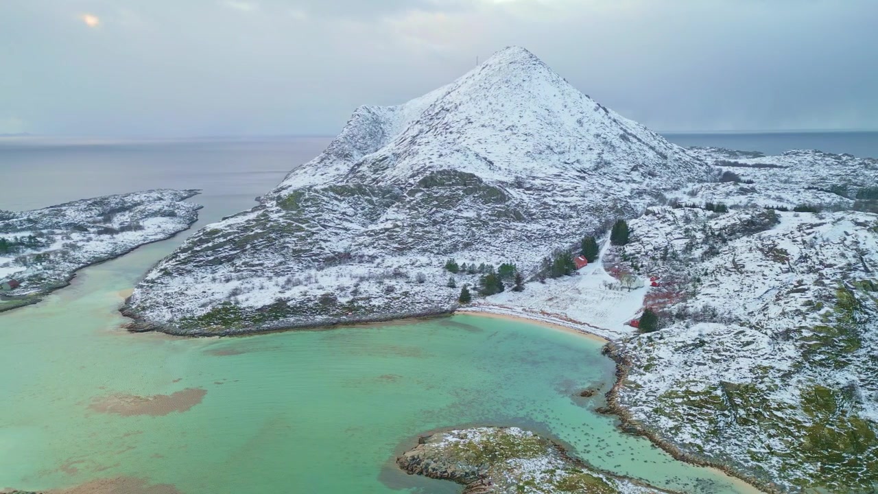 Snowy mountain and coastline in Lofoten, Norway, peaceful winter landscape