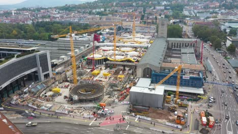 aerial helix of huge railroads and construction site of main train station stuttgart s21 with cranes and construction workers in stuttgart, germany