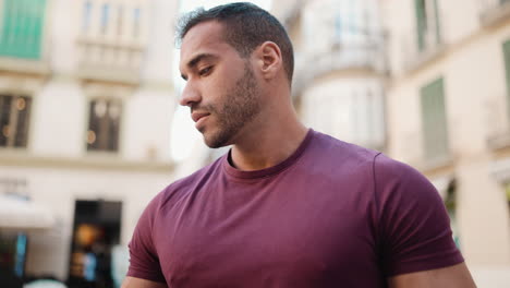 Young-man-searching-for-location-on-smartphone-outdoors.