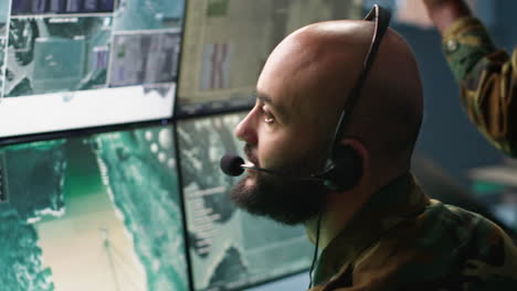 close up on dispatcher working in war room operating surveillance tech