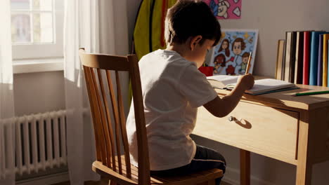 child doing homework at a desk