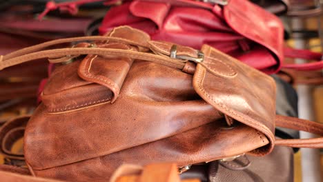collection of brown leather bags and backpacks