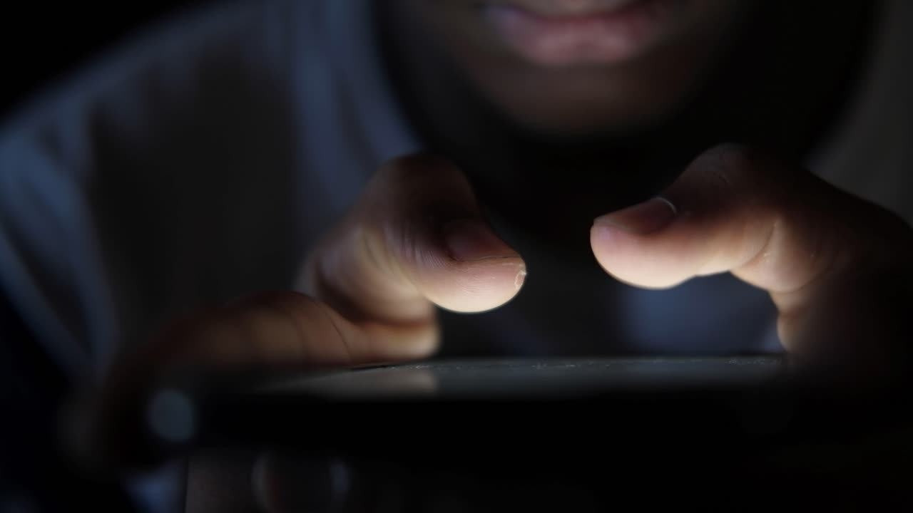 Person using a smartphone at night