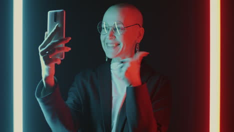 woman taking a selfie in neon light