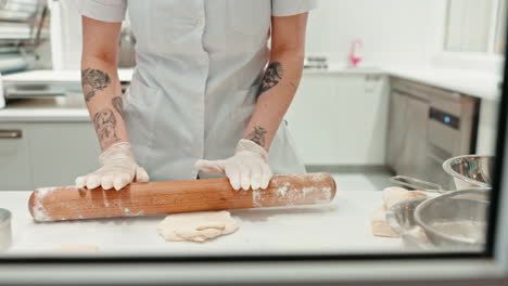 hands, chef and roller with dough in restaurant