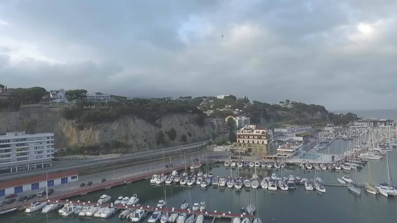 One white balloon flies in sky above Arenys de Mar, Spain. Aerial
