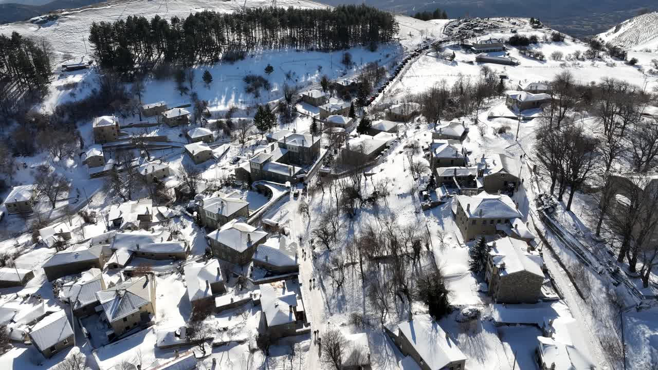 Aerial view of the town of Nymfaio in harsh winter with lots of snow on the rooftops. Florina, Greece.