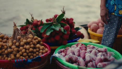 vietnamese street fruit vendor selling tropical fruits on a vibrant market boat