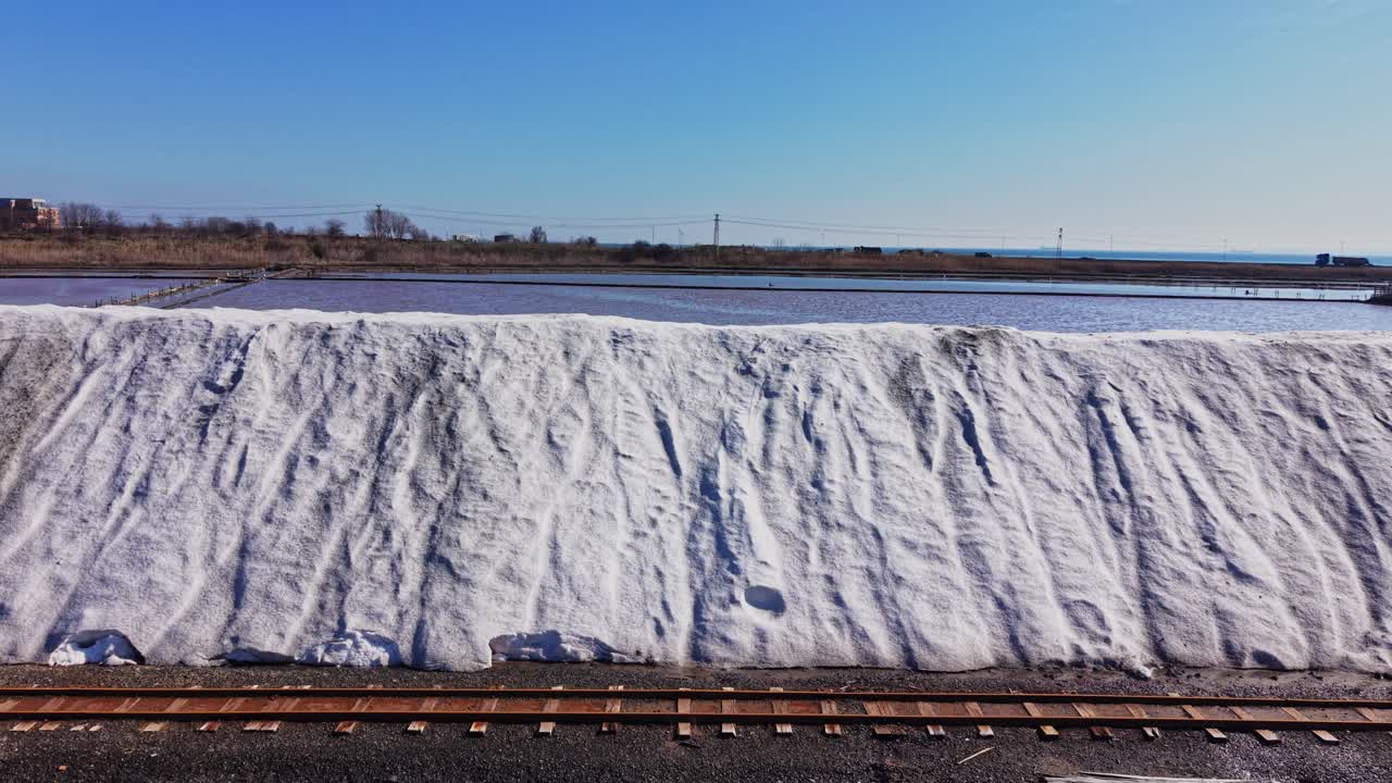 Salt pile at the salt mine near a coastline on a sunny day