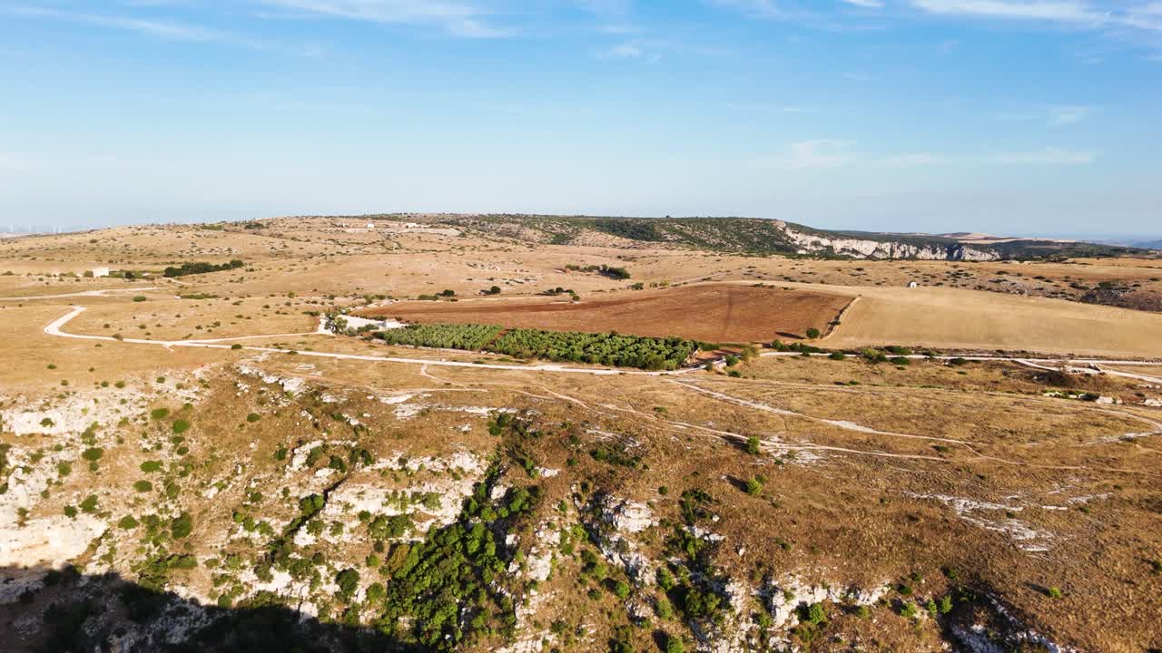 Green plantation and sandy terrain of Italy, aerial view