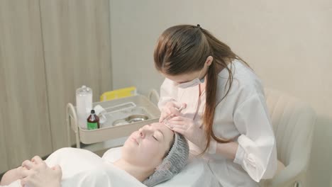 cosmetologist performing facial injection procedure