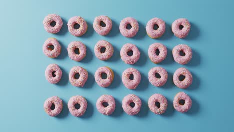 video of donuts with icing on blue background