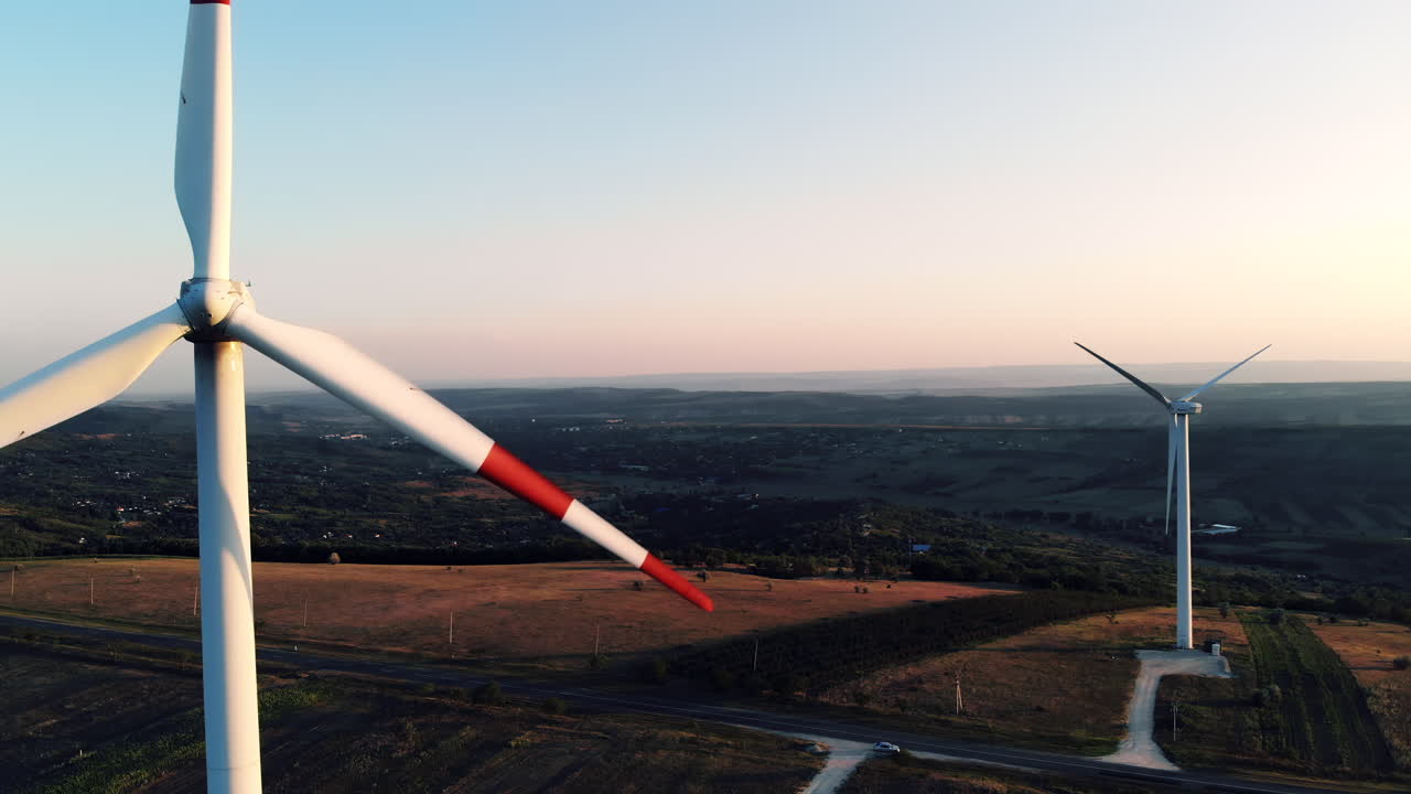 A traditional rural scene featuring a man riding a wooden horse drawn cart along a quiet road lined with old houses and trees