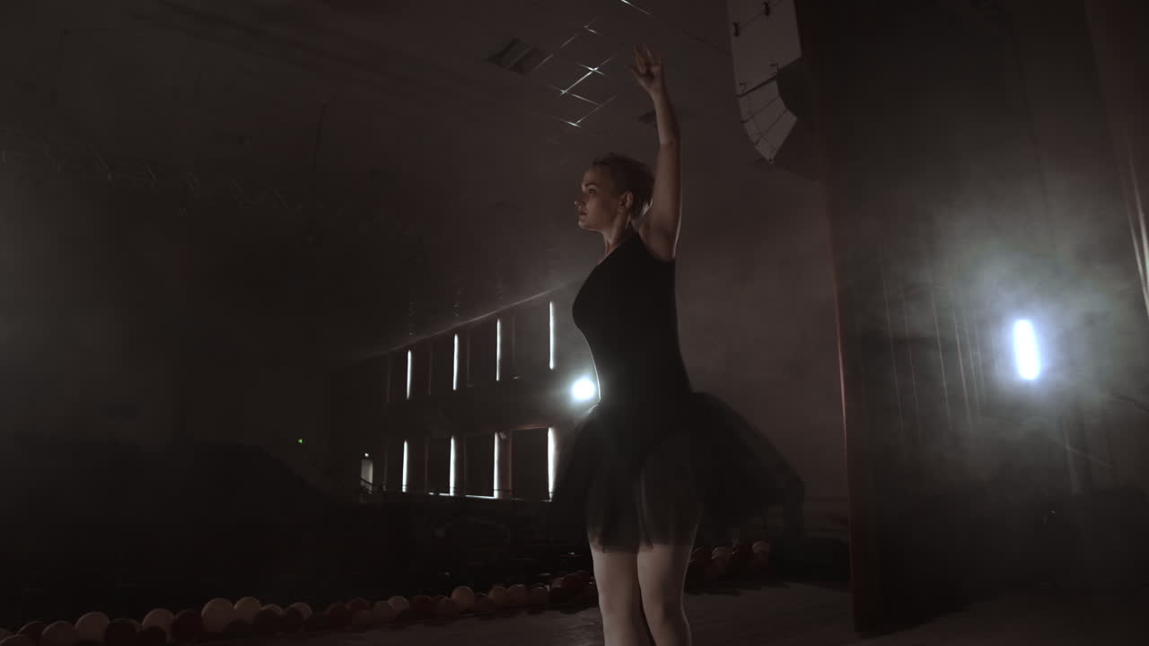 Prima ballet theatre on stage rehearsing performance in the smoke.