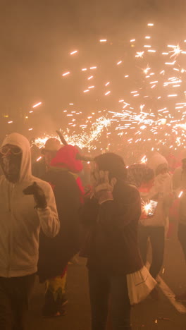 barcelona, spain - 22 september 2023 : crowds in the street for the fire run or correfoc, during la merce festival, barcelona spain in vertical