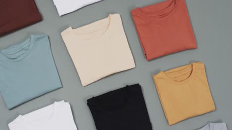 Video-of-flat-lay-of-t-shirts-with-copy-space-on-grey-background