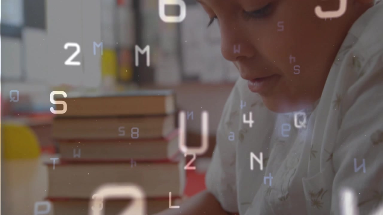 Boy tapping trackpad dragging and typing on laptop showing floating letters, numbers for studying