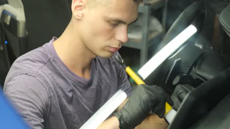 man detailing a car