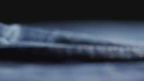 panning shot of denim jeans during manufacturing in a sweatshop, indigo blue fabric