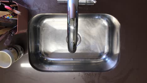 Man-washes-and-prepares-hummingbird-feeder-sequence,-shot-above-the-sink-view