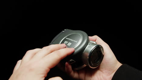 old vintage video camera close-up. popular retro camcorder shooting. opening video-camera on black background