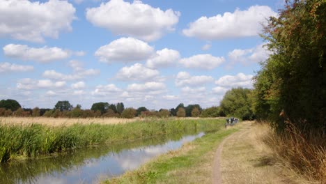 wide shot of british countryside with trent and mersey canal on a sunny day