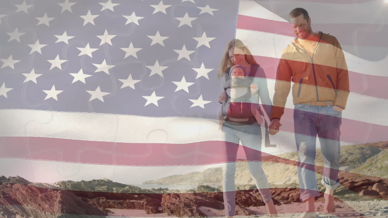 animación de agitar la bandera estadounidense contra una pareja caucásica con un bebé caminando por la playa