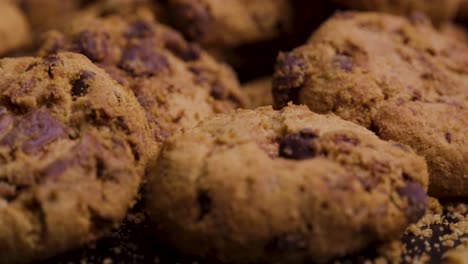 extremely close up shot of vegan or vegetarian cookies with chocolate on black background