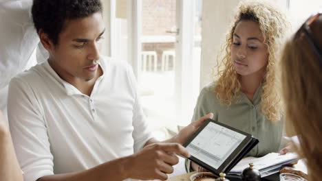 Teamwork-business-start-up-meeting-in-cafe-architectural-sketch-planning-mixed-race-team