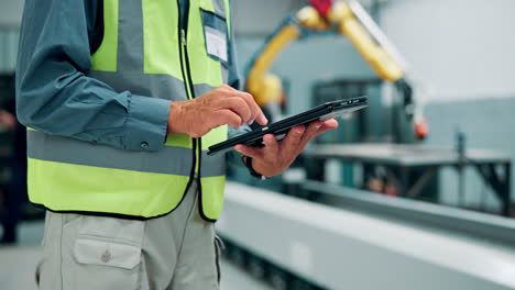 factory worker using tablet in a modern manufacturing facility