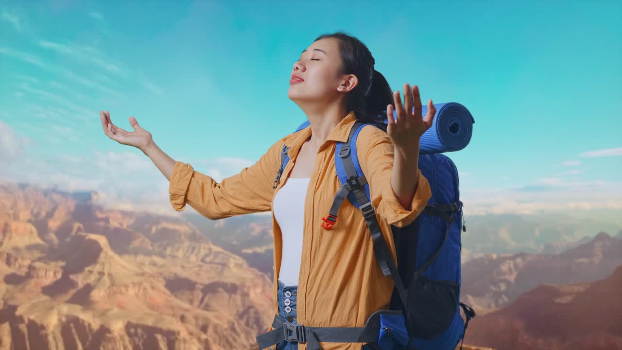 Side View Of Asian Female Hiker With Mountaineering Backpack Smiling And Spreading Arms Enjoy Looking The View Around While Traveling At The Top Of Mountain