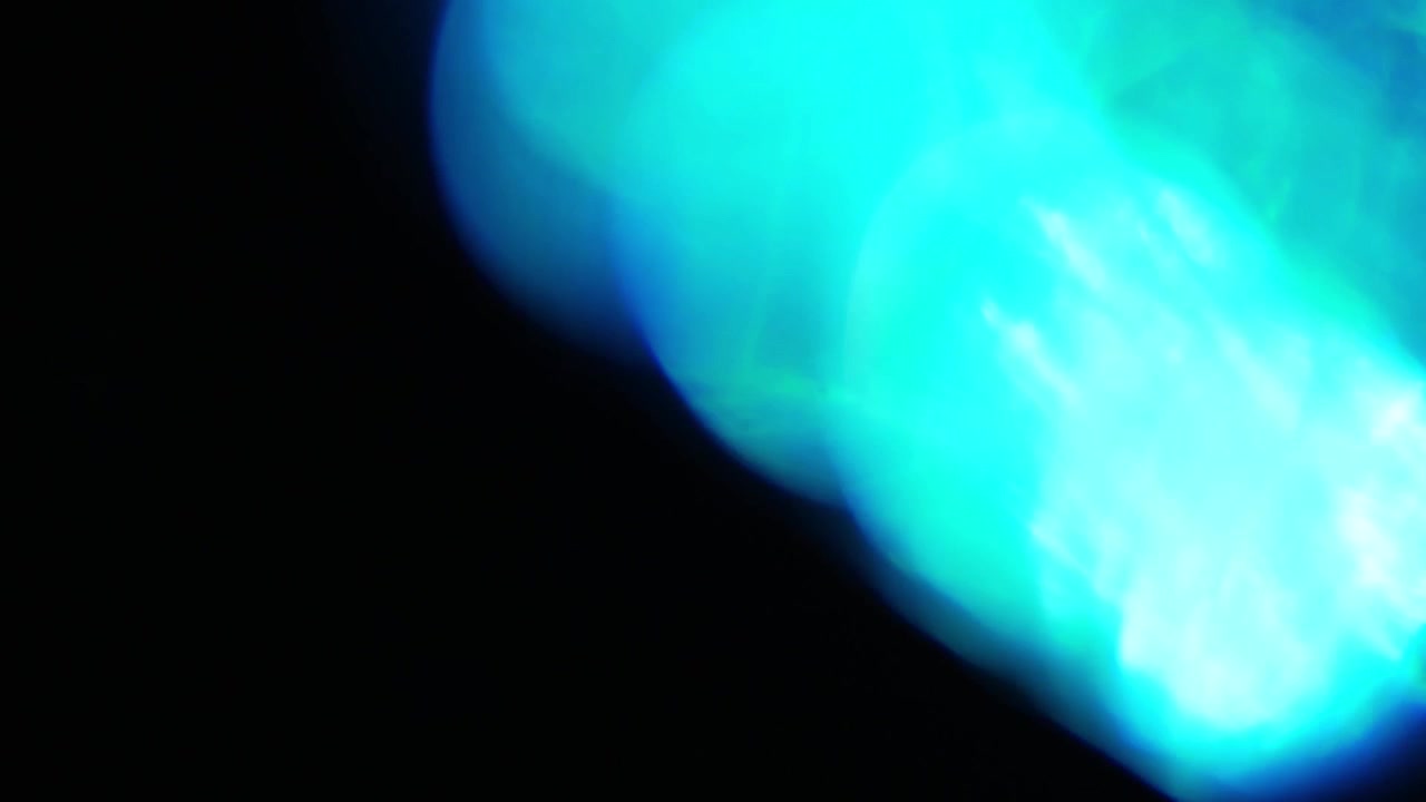 Abstract Blue and Green Light Leaks Transition on Black Background