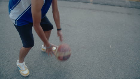 young basketball player dribbling on outdoor court