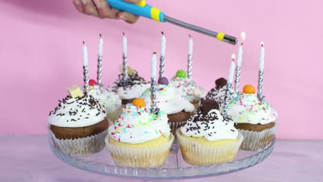 lighting up candles on cup cakes for birthday party