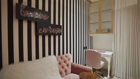 a luxurious room featuring a pink quilted sofa adorned with a plush throw blanket - pan up shot