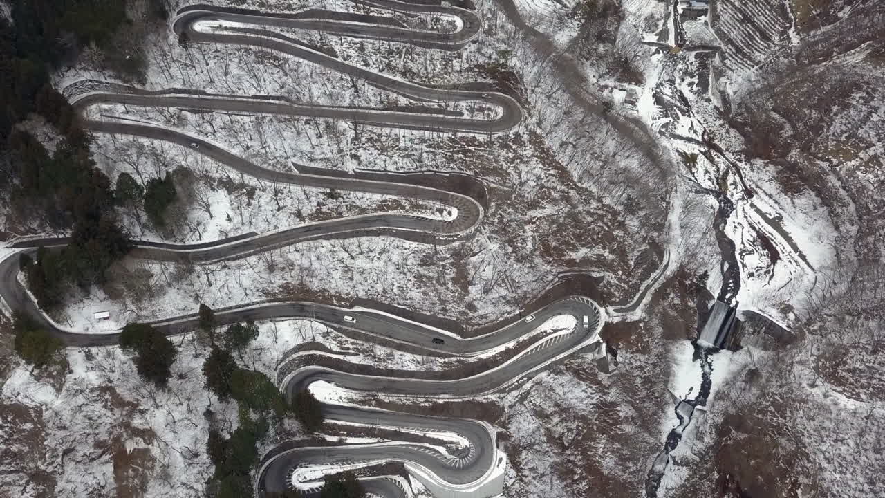 Winter traffic moving slowly down the Irohazaka Winding Road, Nikko, Tochigi, Japan