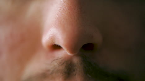 man with a moustache adding nose spray- slow motion, close up shot