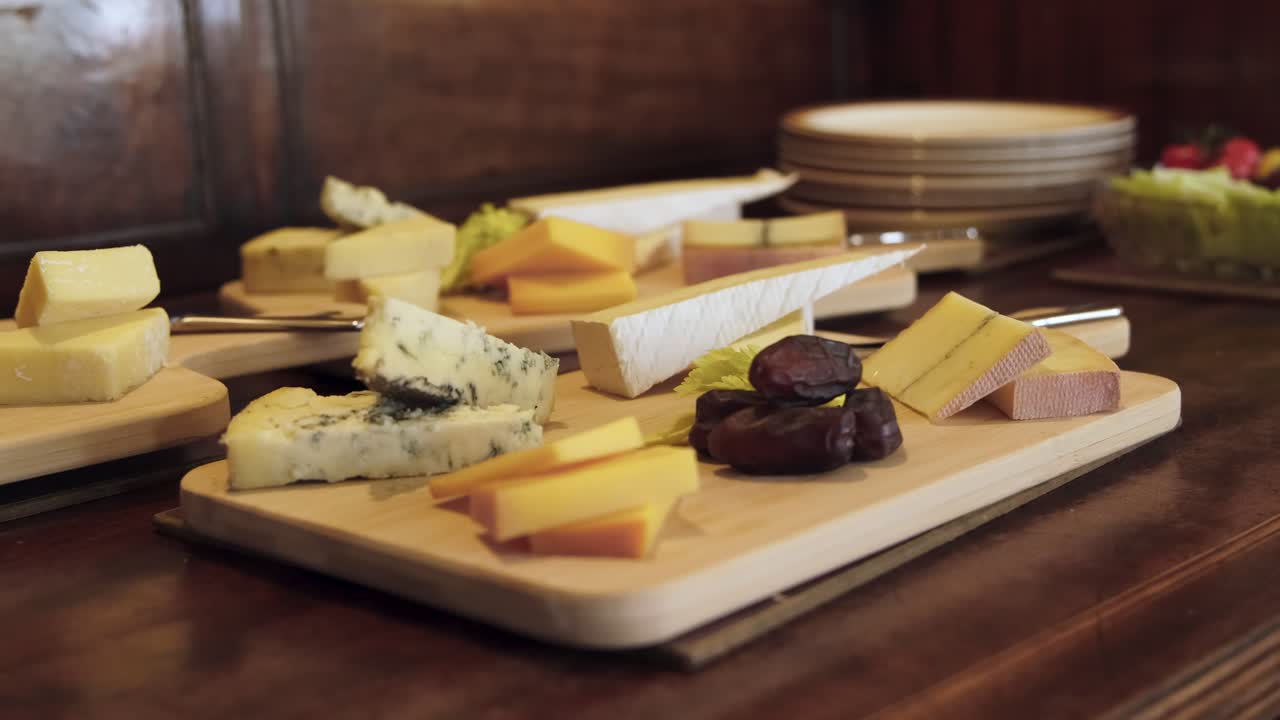 Close up of cheese board with dates and different selection of cheeses at local restaurant.
