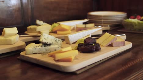 close up of cheese board with dates and different selection of cheeses at local restaurant.